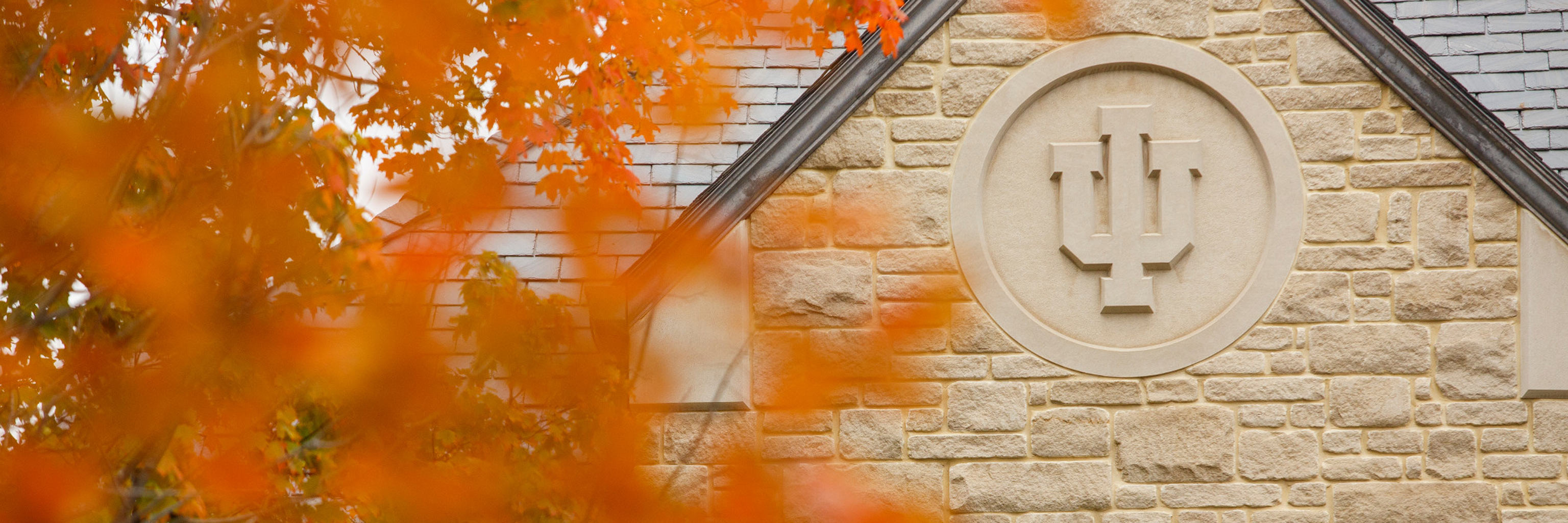 IU trident carved into the side of a limestone building