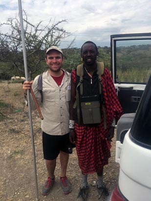 Ryan Yohler posing with another man out in the field