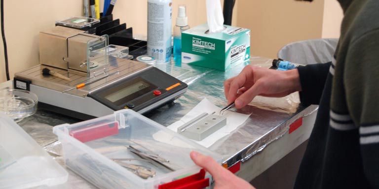 Close up of hands working in a lab